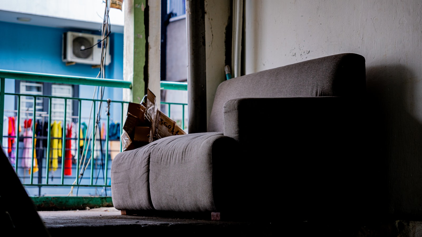 Sofa in a dimly lit room with balcony view