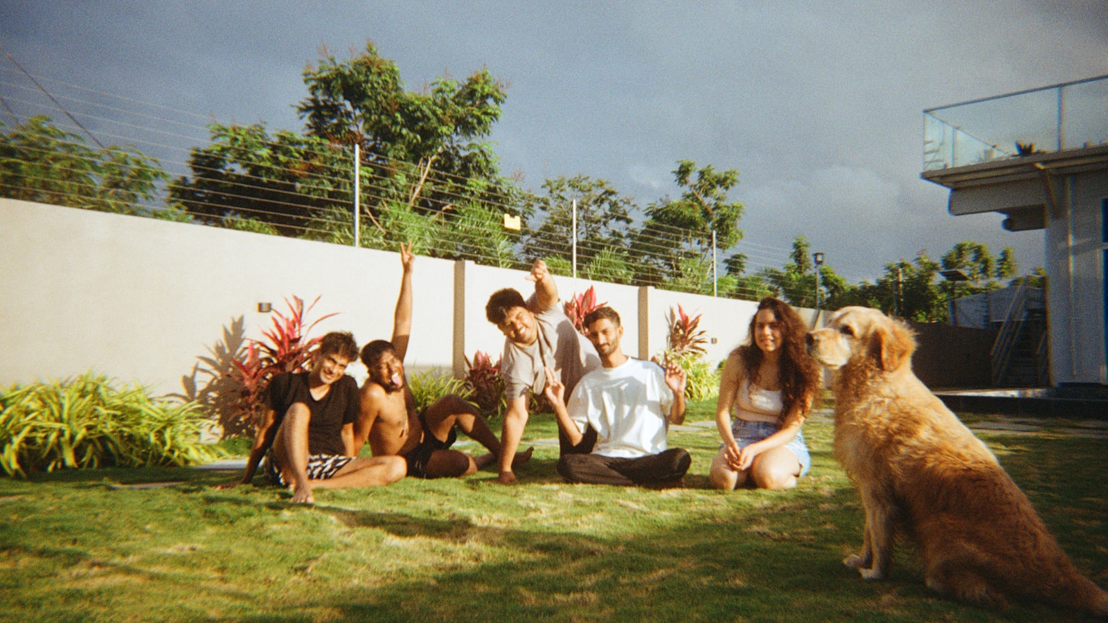 Family and dog posing for a picture outdoors